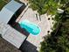 Aerial view of the pool area with lounge chairs and tropical landscaping at 2915 67Th Way N, St Petersburg, FL 33710