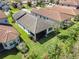 Aerial view of the property showcases the gray tile roof, backyard, and neighboring homes in the community at 31046 Lindentree Dr, Wesley Chapel, FL 33543