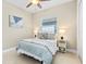 Inviting bedroom with a ceiling fan, a soft color scheme and a comfortable bed for restful nights at 31046 Lindentree Dr, Wesley Chapel, FL 33543