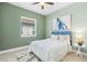 Relaxing bedroom features a decorative ceiling fan, neutral color scheme, and a comfortable bed with stylish bedding at 31046 Lindentree Dr, Wesley Chapel, FL 33543