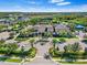 An aerial view of the stunning clubhouse is surrounded by manicured landscaping and ample parking at 31046 Lindentree Dr, Wesley Chapel, FL 33543