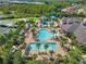 Aerial view showcases the community's expansive pool area, including a lap pool, lounge area, and a ' splash zone at 31046 Lindentree Dr, Wesley Chapel, FL 33543