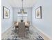Modern dining room featuring stylish decor, a contemporary light fixture, and a decorative rug at 31046 Lindentree Dr, Wesley Chapel, FL 33543