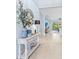 Inviting entryway with stylish decor, including a decorative mirror, table, and view to the living area at 31046 Lindentree Dr, Wesley Chapel, FL 33543