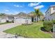 Charming single-story home with a well-manicured lawn, stone accents, and a two-car garage at 31046 Lindentree Dr, Wesley Chapel, FL 33543