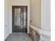 Elegant front door with decorative glass, complemented by stone accents and a brick walkway at 31046 Lindentree Dr, Wesley Chapel, FL 33543