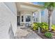 Inviting front porch featuring a cozy seating area and lush landscaping, perfect for relaxing at 31046 Lindentree Dr, Wesley Chapel, FL 33543