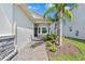 Charming walkway leads to the home's entrance, surrounded by lush landscaping and palm trees at 31046 Lindentree Dr, Wesley Chapel, FL 33543