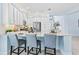 Stylish kitchen with an island featuring seating, stainless steel appliances, and white cabinets at 31046 Lindentree Dr, Wesley Chapel, FL 33543