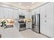 Well-equipped kitchen with stainless steel appliances and white cabinets for a modern look at 31046 Lindentree Dr, Wesley Chapel, FL 33543