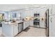 Bright kitchen featuring stainless steel appliances, white cabinetry, and light countertops at 31046 Lindentree Dr, Wesley Chapel, FL 33543