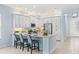 Elegant kitchen with island seating, stainless steel appliances, and white cabinets at 31046 Lindentree Dr, Wesley Chapel, FL 33543