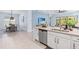 Open kitchen layout with stainless steel appliances and a view of the adjacent dining area at 31046 Lindentree Dr, Wesley Chapel, FL 33543