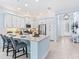 Modern kitchen with white cabinets, stainless steel appliances, and a breakfast bar with seating at 31046 Lindentree Dr, Wesley Chapel, FL 33543