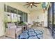 Relaxing screened lanai with brick floors, cozy seating, and a view of the tranquil outdoor setting at 31046 Lindentree Dr, Wesley Chapel, FL 33543