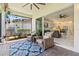 Covered lanai with brick floors, comfortable seating and a view of the backyard, perfect for relaxing outdoors at 31046 Lindentree Dr, Wesley Chapel, FL 33543