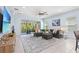 Spacious living room with comfortable seating, stylish decor, and access to the outdoor patio at 31046 Lindentree Dr, Wesley Chapel, FL 33543