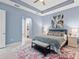 Neutral main bedroom features tray ceilings, tile flooring, and adjoins a walk-in closet at 31046 Lindentree Dr, Wesley Chapel, FL 33543
