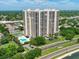 Aerial view showcasing the building, pool, tennis courts, and lush landscaping of this gorgeous property at 3301 Bayshore Blvd # 2007B, Tampa, FL 33629