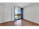 Bedroom with wood flooring, large windows and sheer curtains at 3301 Bayshore Blvd # 2007B, Tampa, FL 33629