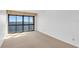 Neutral bedroom featuring a large picture window with scenic views and light-colored carpet at 3301 Bayshore Blvd # 2007B, Tampa, FL 33629