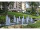 Inviting building entrance with lush landscaping and a decorative water fountain at 3301 Bayshore Blvd # 2007B, Tampa, FL 33629