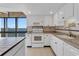 Bright kitchen with white cabinets, granite countertops, and modern appliances with waterfront view at 3301 Bayshore Blvd # 2007B, Tampa, FL 33629