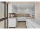 Well-lit kitchen with white cabinetry, tile backsplash, and modern appliances with waterfront view at 3301 Bayshore Blvd # 2007B, Tampa, FL 33629