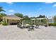 Outdoor community patio with stone pavers, pergola, seating, and built-in grill at 3301 Bayshore Blvd # 2007B, Tampa, FL 33629