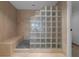 Modern shower featuring glass block wall, tile floors, and a built-in bench at 3301 Bayshore Blvd # 2007B, Tampa, FL 33629