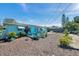 Spacious backyard with mulched area, outdoor seating, and a light blue home exterior at 3307 Maitland Dr, Holiday, FL 34691