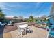 Landscaped backyard featuring a patio with seating, decorative rock, and lush, mature landscaping at 3307 Maitland Dr, Holiday, FL 34691