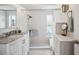Elegant bathroom showcasing granite countertops, a walk-in shower, and white tiled walls at 3307 Maitland Dr, Holiday, FL 34691