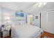Calm bedroom features blue walls, hardwood floors, ceiling fan, closet, and a side table at 3307 Maitland Dr, Holiday, FL 34691