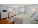 Bright bedroom with blue walls, hardwood floors, wicker dresser and natural light at 3307 Maitland Dr, Holiday, FL 34691