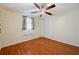 Bedroom featuring hardwood floors, a ceiling fan, and white closet doors at 3307 Maitland Dr, Holiday, FL 34691