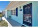 Charming home exterior with a blue door, shutters, and a manicured front yard at 3307 Maitland Dr, Holiday, FL 34691