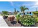 Charming light blue home featuring lush landscaping and a vibrant mix of colorful plants at 3307 Maitland Dr, Holiday, FL 34691