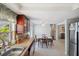 Open kitchen and dining area with stainless steel fridge, tile floor, and plenty of space at 3307 Maitland Dr, Holiday, FL 34691