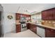 Well-lit kitchen features stainless steel appliances, tile floors, and a window offering natural light at 3307 Maitland Dr, Holiday, FL 34691