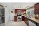 Well-lit kitchen features stainless steel appliances, tile floors, and a window offering natural light at 3307 Maitland Dr, Holiday, FL 34691