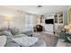 Cozy living room with white accents, a large window, and comfortable seating arrangement at 3307 Maitland Dr, Holiday, FL 34691