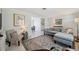 Bright and open living room with neutral tones and a view into the dining area at 3307 Maitland Dr, Holiday, FL 34691