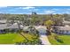 Aerial view of the home, highlighting the well-manicured lawn, mature trees, and surrounding neighborhood at 3370 Harbor Lake Dr, Largo, FL 33770