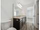 Bathroom vanity with dark wood cabinets and a large mirror at 35138 Daisy Meadow Loop, Zephyrhills, FL 33541