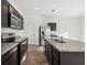 The kitchen features granite countertops, a stainless steel refrigerator, and wooden cabinets at 35138 Daisy Meadow Loop, Zephyrhills, FL 33541