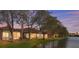 Backyard of a home offering a serene view of the water and lush landscaping at 3876 Timber Ridge Ct, Palm Harbor, FL 34685