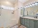 Bathroom featuring a new shower and custom vanity with mirror at 3876 Timber Ridge Ct, Palm Harbor, FL 34685