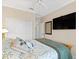 Cozy bedroom featuring a ceiling fan, ensuite bathroom, closet, and a comfortable bed at 3876 Timber Ridge Ct, Palm Harbor, FL 34685