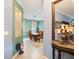 Dining room adjacent to the hall features a wooden table at 3876 Timber Ridge Ct, Palm Harbor, FL 34685